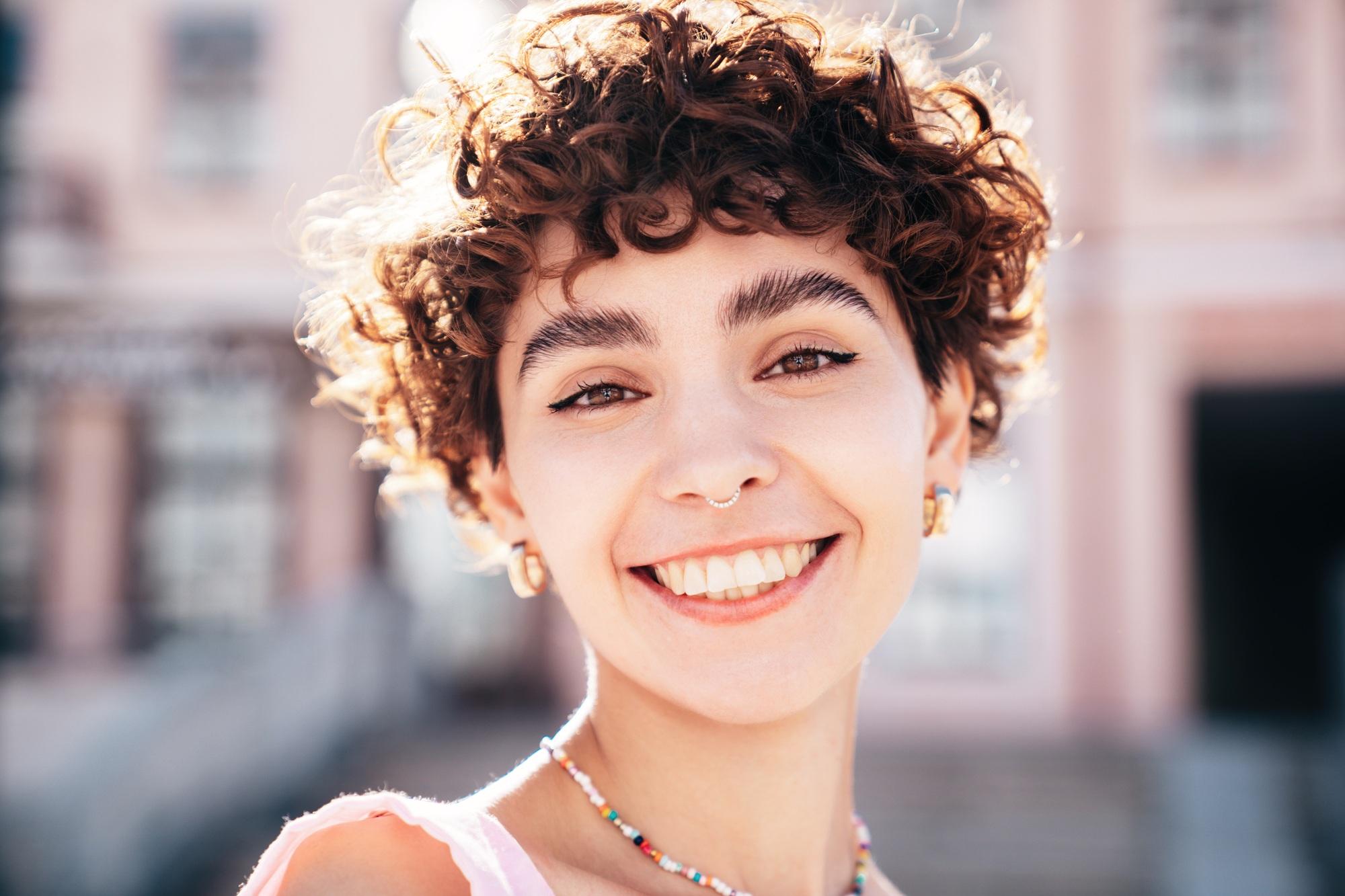 Young beautiful smiling hipster woman
